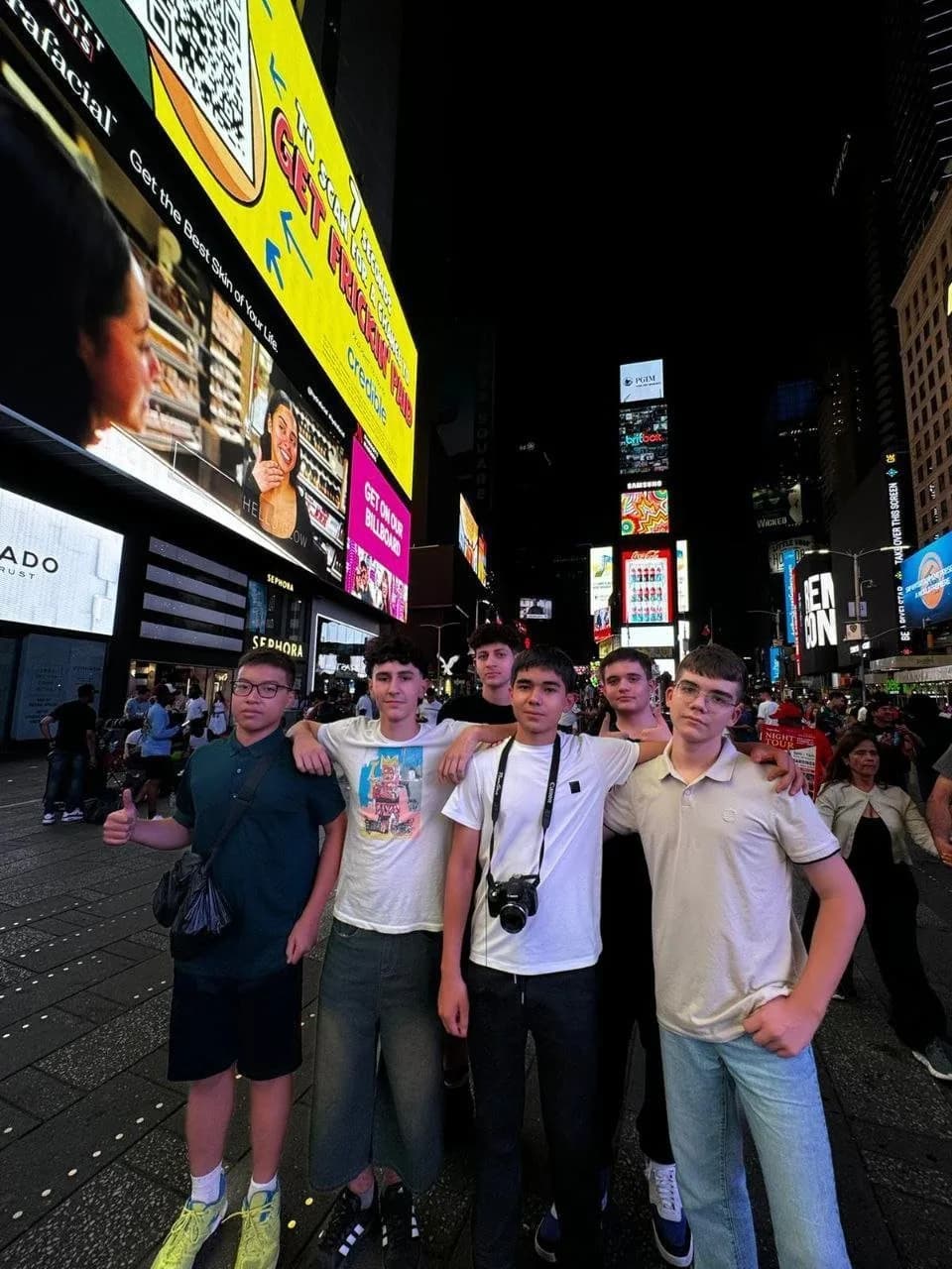 Camp friends at night in Times Square, New York